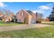 Spacious brick home with a large driveway and a well-manicured lawn at 2425 Birdie Ne Ln, Conover, NC 28613