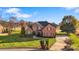 Beautiful two-story brick home with well-manicured lawn and mature trees at 2425 Birdie Ne Ln, Conover, NC 28613