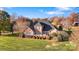 An aerial view of this brick house, situated on a manicured lawn with various landscaping at 2425 Birdie Ne Ln, Conover, NC 28613