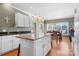 Open kitchen features an island, granite counters, and stainless steel appliances, and a view into the dining area at 2425 Birdie Ne Ln, Conover, NC 28613