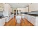 Well-lit kitchen features an island with bar seating, granite counters, and stainless steel appliances at 2425 Birdie Ne Ln, Conover, NC 28613