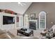 Comfortable living room with fireplace, arched windows, and carpet flooring at 2425 Birdie Ne Ln, Conover, NC 28613