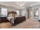 Well-lit main bedroom with a ceiling fan, tray ceilings, and plenty of natural light at 2425 Birdie Ne Ln, Conover, NC 28613