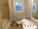 Well-lit bathroom features a shower-tub, white sink, and neutral walls at 8600 E Highway 74 E Hwy, Marshville, NC 28103