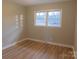 Neutral bedroom featuring wood-look flooring and natural light from a window at 8600 E Highway 74 E Hwy, Marshville, NC 28103