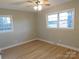 Bright bedroom with a ceiling fan, new flooring, and double hung windows with neighborhood views at 8600 E Highway 74 E Hwy, Marshville, NC 28103