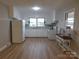 Well-lit kitchen with white appliances, cabinets, and wood-look flooring at 8600 E Highway 74 E Hwy, Marshville, NC 28103