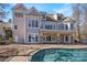 Back of house boasts a pool and spacious patio at 148 Quaker Rd, Mooresville, NC 28117