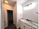 Bathroom featuring a marble vanity, a sink and black fixtures, and an adjacent linen closet at 1589 Maysville Rd, Shelby, NC 28150