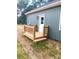 New wood deck and entry with painted siding and lush green lawn surrounding the home at 1589 Maysville Rd, Shelby, NC 28150