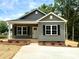 Charming single-Gathering home showcasing a well-manicured lawn and a delightful covered porch at 1589 Maysville Rd, Shelby, NC 28150