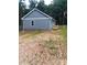 Exterior view of a home with green siding, a new deck and well-maintained lawn at 1589 Maysville Rd, Shelby, NC 28150