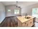 Bright kitchen featuring a marble island, stainless steel appliances, and wood-look floors at 1589 Maysville Rd, Shelby, NC 28150