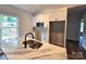 Modern kitchen with white cabinets, a marble island with a stainless sink, and stainless appliances at 1589 Maysville Rd, Shelby, NC 28150