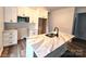 Beautiful kitchen with white cabinetry, granite countertops, a stainless microwave, and modern fixtures at 1589 Maysville Rd, Shelby, NC 28150