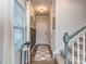 Bright entryway with checkerboard floor, built-in storage, and staircase at 2123 Belterra Dr, Charlotte, NC 28216