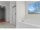 Bright bathroom features a soaking tub, tiled shower, and window with a view at 3110 Westerwood Dr, Charlotte, NC 28214