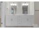 Bathroom boasts double sink vanity with ample storage and modern lighting fixtures at 3110 Westerwood Dr, Charlotte, NC 28214