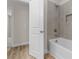 Modern bathroom with gray tiled shower, a built-in niche, and door to the hallway at 3110 Westerwood Dr, Charlotte, NC 28214