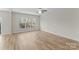 Bedroom with ceiling fan, and large window overlooking the front yard at 3110 Westerwood Dr, Charlotte, NC 28214