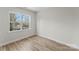 Bright bedroom showing natural light from a large window, neutral walls, and wood-look flooring at 3110 Westerwood Dr, Charlotte, NC 28214