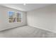 Comfortable bedroom with soft carpet and a bright window with scenic outdoor views at 3110 Westerwood Dr, Charlotte, NC 28214
