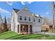 Exterior view of a modern two-story home showcasing gray siding, a brick porch, and an attached garage at 3110 Westerwood Dr, Charlotte, NC 28214