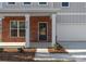 Charming front porch with brick accents and white columns, leading to the front door and an attached garage at 3110 Westerwood Dr, Charlotte, NC 28214