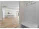 Hallway showcases modern open floor plan with a hall tree and views into the kitchen at 3110 Westerwood Dr, Charlotte, NC 28214