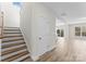 Hallway with hardwood floors, leading to a staircase and an open-concept living area filled with natural light at 3110 Westerwood Dr, Charlotte, NC 28214