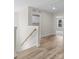 Bright hallway with wood floors, white walls, and natural light coming through the open doorway at 3110 Westerwood Dr, Charlotte, NC 28214