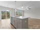 Bright kitchen with island sink, and view of the natural backyard at 3110 Westerwood Dr, Charlotte, NC 28214