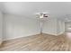 Large living room with ceiling fan and vinyl plank flooring at 3110 Westerwood Dr, Charlotte, NC 28214