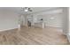 Open-concept living space showcasing hardwood floors flowing into kitchen with stainless appliances and island at 3110 Westerwood Dr, Charlotte, NC 28214