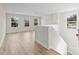 Open-concept living room boasts hardwood flooring, neutral paint, and plenty of natural light from multiple windows at 3110 Westerwood Dr, Charlotte, NC 28214