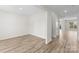 Open-concept living room with wood-look floors, neutral walls, and an entryway at 3110 Westerwood Dr, Charlotte, NC 28214