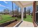 View from the porch, overlooking a well-maintained lawn and surrounding trees, offering a serene outdoor space at 3110 Westerwood Dr, Charlotte, NC 28214