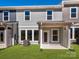 Backyard with a small lawn and a covered patio area, perfect for outdoor relaxation at 161 Halite Ln, Waxhaw, NC 28173