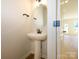 Stylish powder room features pedestal sink and modern fixtures at 161 Halite Ln, Waxhaw, NC 28173