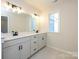 Bright bathroom with double vanity, modern lighting and light tile flooring at 161 Halite Ln, Waxhaw, NC 28173