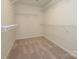 Walk-in closet with ample shelving and neutral carpeting at 161 Halite Ln, Waxhaw, NC 28173