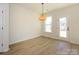 Dining room with wood floors, modern light fixture, and a view of the backyard at 161 Halite Ln, Waxhaw, NC 28173