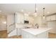 Modern kitchen featuring white cabinets, a large island, stainless steel appliances, and pendant lighting at 161 Halite Ln, Waxhaw, NC 28173