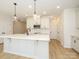 Spacious kitchen with a large island, sleek white countertops, modern appliances, and stylish lighting fixtures at 161 Halite Ln, Waxhaw, NC 28173