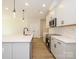 Contemporary kitchen featuring stainless steel appliances, white cabinetry, and a large island with a sink at 161 Halite Ln, Waxhaw, NC 28173