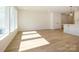 Sunlit room with wood-look floors and ample natural light from large windows at 161 Halite Ln, Waxhaw, NC 28173