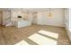 Open living space merges with a modern kitchen, featuring an island and sleek white cabinetry at 161 Halite Ln, Waxhaw, NC 28173