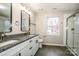 Modern main bathroom with double sink vanity, granite counters, and glass enclosed shower at 316 Reed Creek Rd, Mooresville, NC 28117