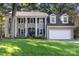 Two-story house with columns, a spacious lawn, and a two-car garage at 416 Sabot Ln, Matthews, NC 28105