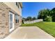 This brick home features an outdoor patio and a well-manicured backyard with a white picket fence at 7534 April Mist Trl, Huntersville, NC 28078
